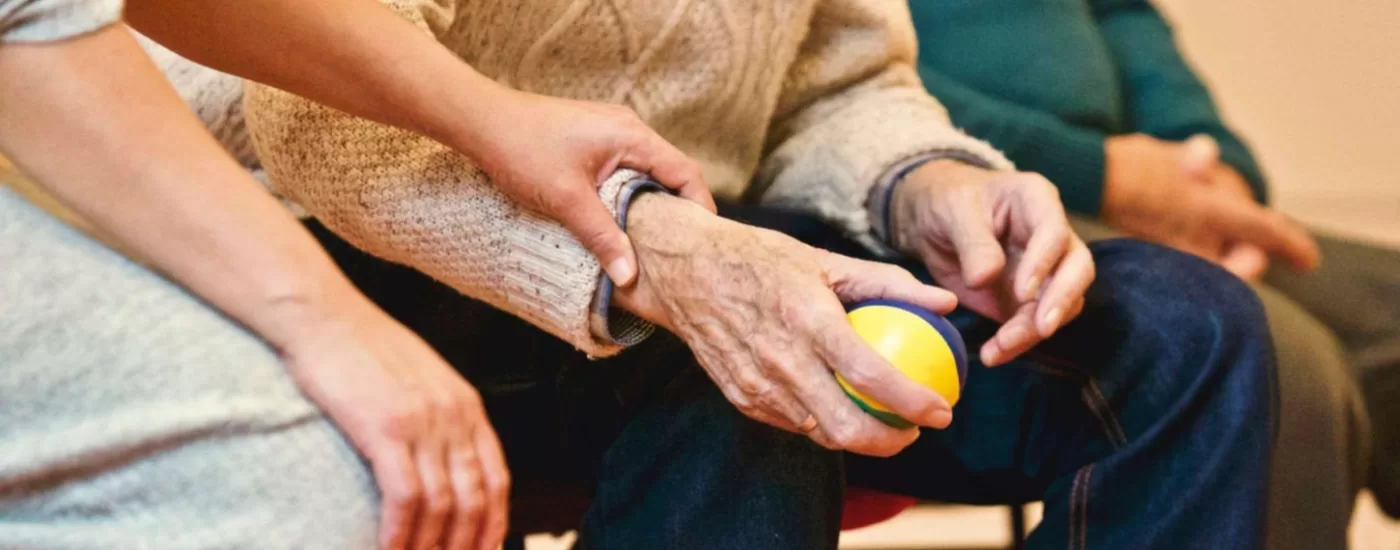 young holding arm of elderly man