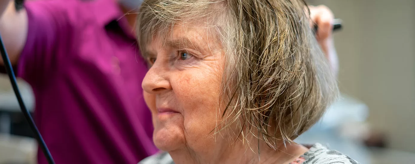 A resident having their hair cut